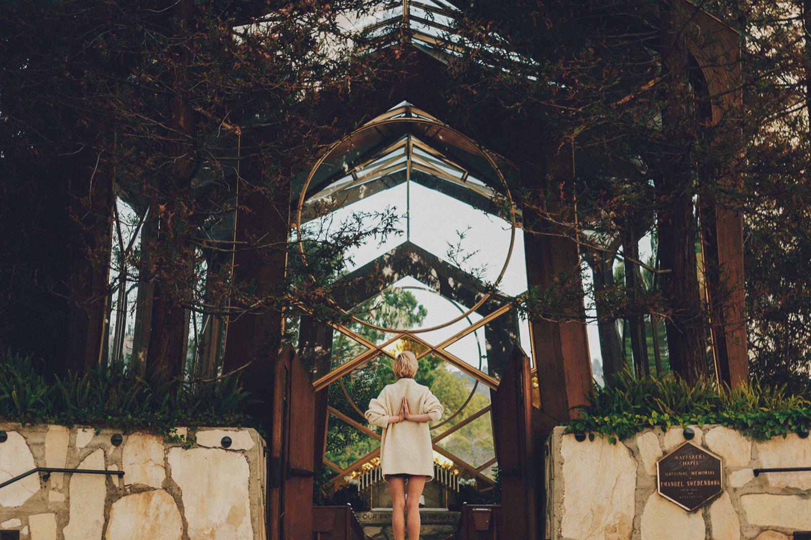 Wayfarers Chapel's glass and redwood sanctuary among trees, photographed before the chapel was dismantled